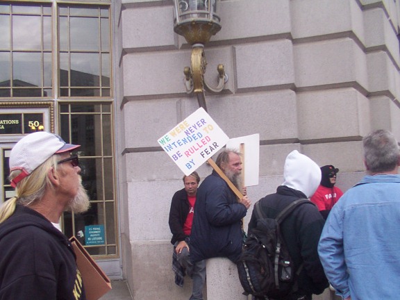 EC Daniel Jeffrey of Church of Cognizance on left and holding sign in center is Rev. Jeff Brown of the Ethiopion Zion Coptic Church.